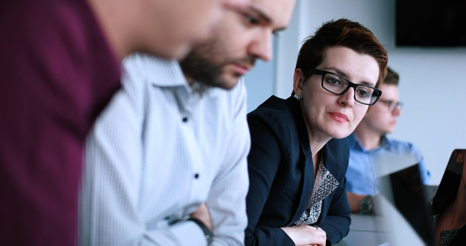 People who make meetings ineffective - woman in a meeting looking bored